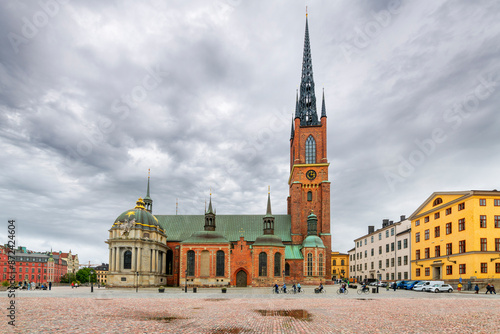 Photography The imposing facade and spire of the Riddarholmen Church, the church of the former medieval Greyfriars Monastery, on an overcast day in Stockholm, Sweden