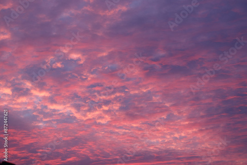 Wall Mural Stunning sky filled with vibrant pink and purple clouds at sunset, creating a dramatic and colorful backdrop
