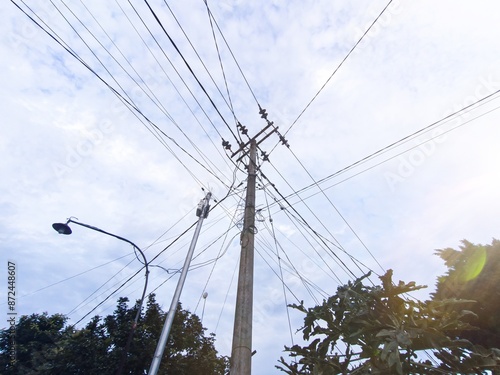 Electric poles with messy cables. Focus on the electric pole, exposure photo