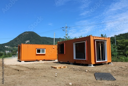 Fotografie Orange shipping container offices near construction site