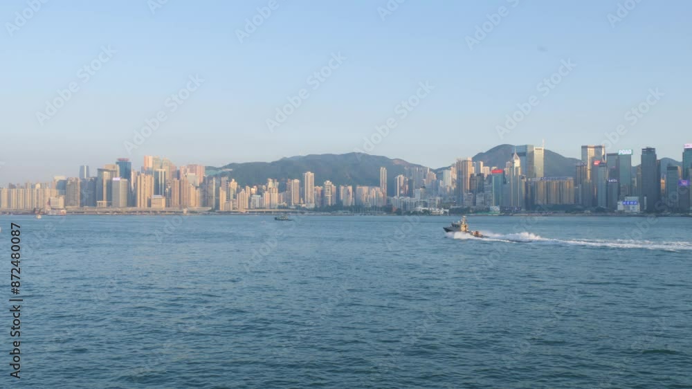 Victoria Harbor in Hong Kong with boats and ferries on a sunny day, skyline in the background Victoria Harbor in Hong Kong with boats and ferries on a sunny day, skyline in the background