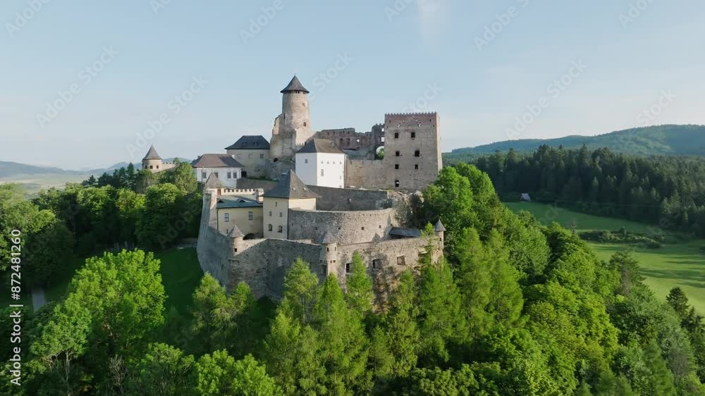 Aerial view of Stara Lubovna Castle in Slovakia, medieval castle on a hill surrounded by a green forest on sunny day (4K) Aerial view of Stara Lubovna Castle in Slovakia, medieval castle on a hill surrounded by a green forest on sunny day (4K)