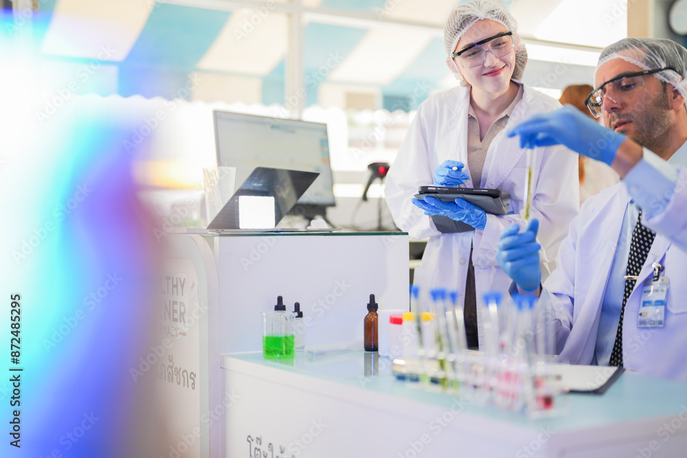 scientists perform experiments and record data. people arranges equipment with test tubes and chemicals for producing medicine and biochemistry. man hold tubes of chemical liquids and plant samples. scientists perform experiments and record data. people arranges equipment with test tubes and chemicals for producing medicine and biochemistry. man hold tubes of chemical liquids and plant samples.
