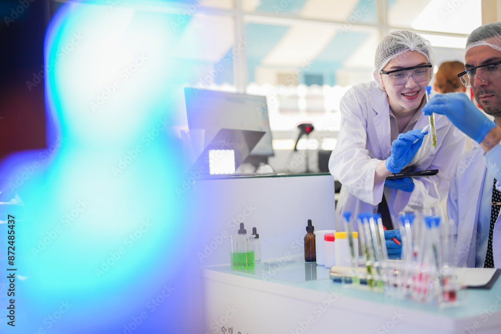 scientists perform experiments and record data. people arranges equipment with test tubes and chemicals for producing medicine and biochemistry. man hold tubes of chemical liquids and plant samples. scientists perform experiments and record data. people arranges equipment with test tubes and chemicals for producing medicine and biochemistry. man hold tubes of chemical liquids and plant samples.