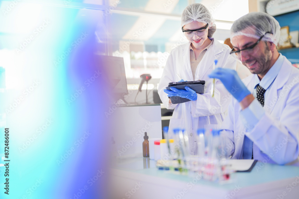 scientists perform experiments and record data. people arranges equipment with test tubes and chemicals for producing medicine and biochemistry. man hold tubes of chemical liquids and plant samples. scientists perform experiments and record data. people arranges equipment with test tubes and chemicals for producing medicine and biochemistry. man hold tubes of chemical liquids and plant samples.