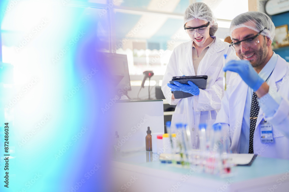 scientists perform experiments and record data. people arranges equipment with test tubes and chemicals for producing medicine and biochemistry. man hold tubes of chemical liquids and plant samples. scientists perform experiments and record data. people arranges equipment with test tubes and chemicals for producing medicine and biochemistry. man hold tubes of chemical liquids and plant samples.