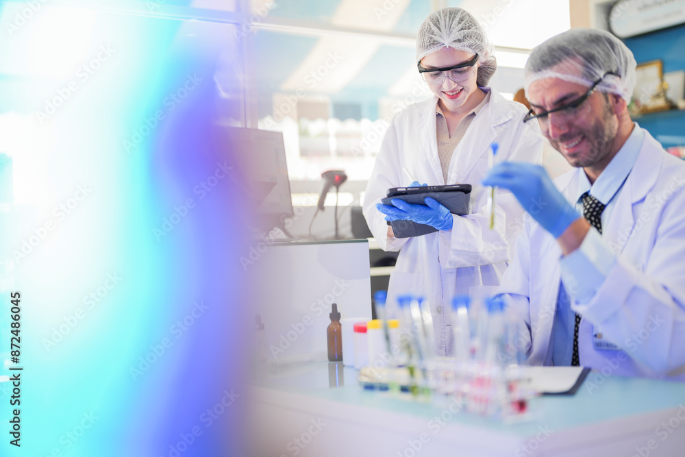 scientists perform experiments and record data. people arranges equipment with test tubes and chemicals for producing medicine and biochemistry. man hold tubes of chemical liquids and plant samples. scientists perform experiments and record data. people arranges equipment with test tubes and chemicals for producing medicine and biochemistry. man hold tubes of chemical liquids and plant samples.