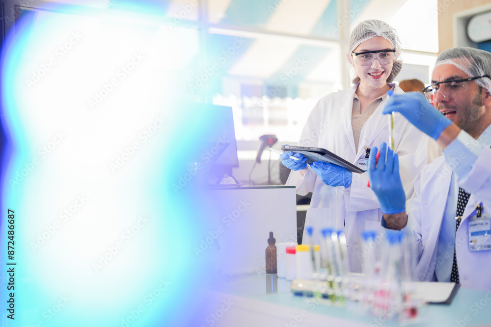 scientists perform experiments and record data. people arranges equipment with test tubes and chemicals for producing medicine and biochemistry. man hold tubes of chemical liquids and plant samples. scientists perform experiments and record data. people arranges equipment with test tubes and chemicals for producing medicine and biochemistry. man hold tubes of chemical liquids and plant samples.