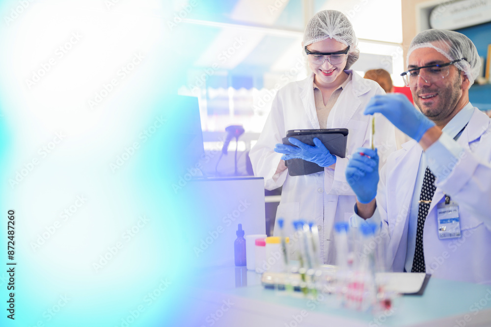 scientists perform experiments and record data. people arranges equipment with test tubes and chemicals for producing medicine and biochemistry. man hold tubes of chemical liquids and plant samples. scientists perform experiments and record data. people arranges equipment with test tubes and chemicals for producing medicine and biochemistry. man hold tubes of chemical liquids and plant samples.