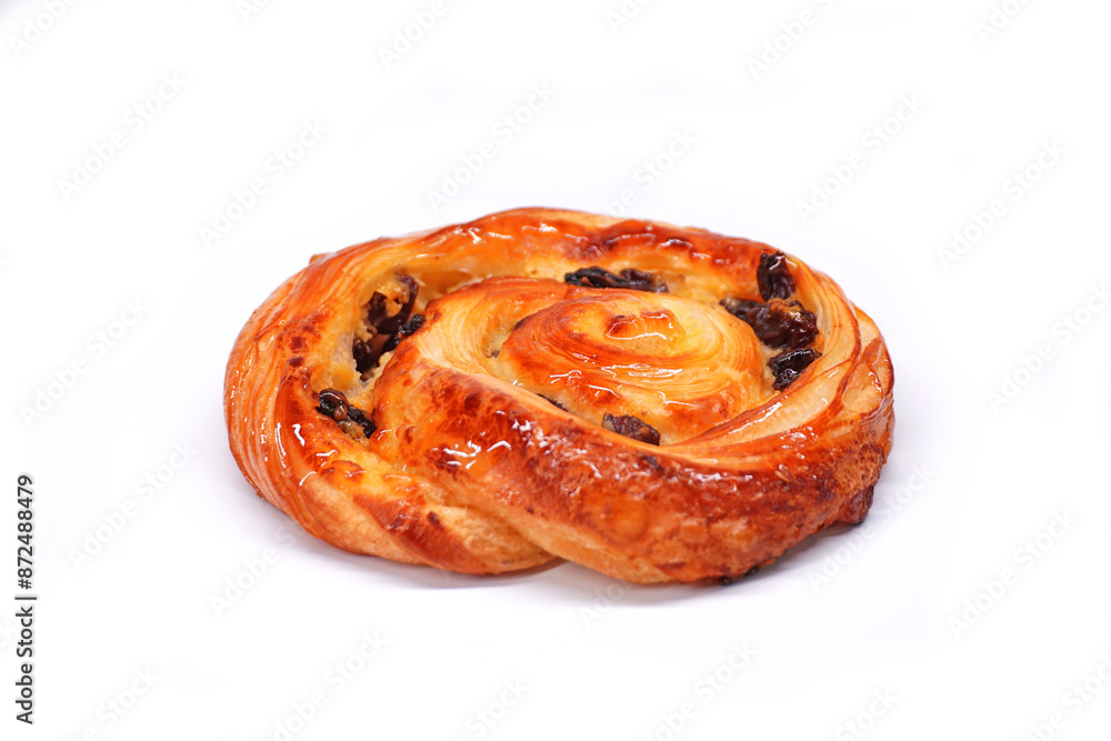 Fototapeta premium Pain aux raisins isolate on white, also called escargot or pain russe, is a spiral pastry often eaten for breakfast in France. Its names translate as 