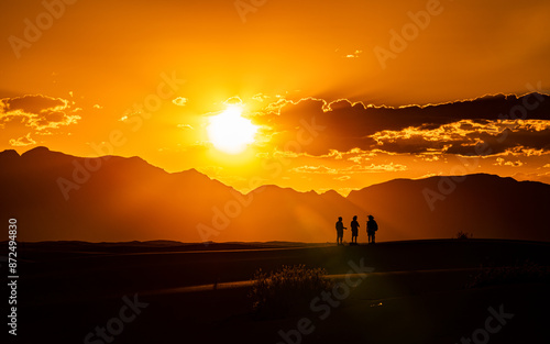 Summer Sunset at White Sand National Park with Silhouette of a Group of Traveler