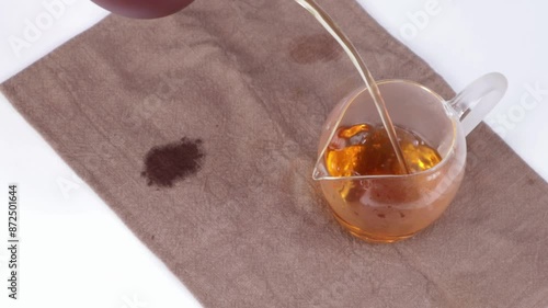 The image of boiling black tea in a glass cup called 