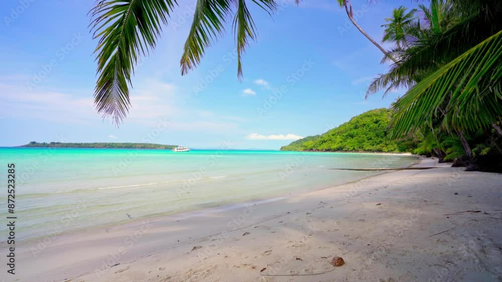 Tropical island with a paradise beach with yellow sand and coconut trees. Turquoise ocean near the sandy coast on a sunny summer day. Summer holidays and tropical beach concept. Tropical island with a paradise beach with yellow sand and coconut trees. Turquoise ocean near the sandy coast on a sunny summer day. Summer holidays and tropical beach concept.