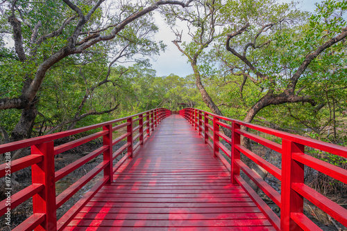 Red wooden bridge in the park.