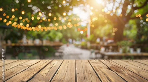 Fototapeta Naklejka Na Ścianę i Meble -  Empty wooden table in summer background with the blurred green garden and party in the background.
