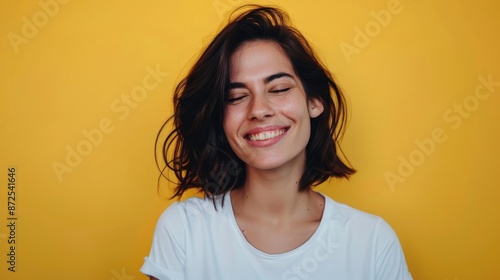 Photo Of A Woman Winking And Smiling On Yellow Background, Wearing White T-Shirt, Half Body Shot, Studio Portrait