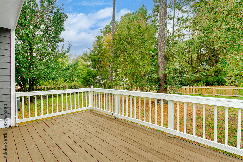 Summer Wooden Deck With White Railings Overlooking Lush Green Backyard Summer Wooden Deck With White Railings Overlooking Lush Green Backyard