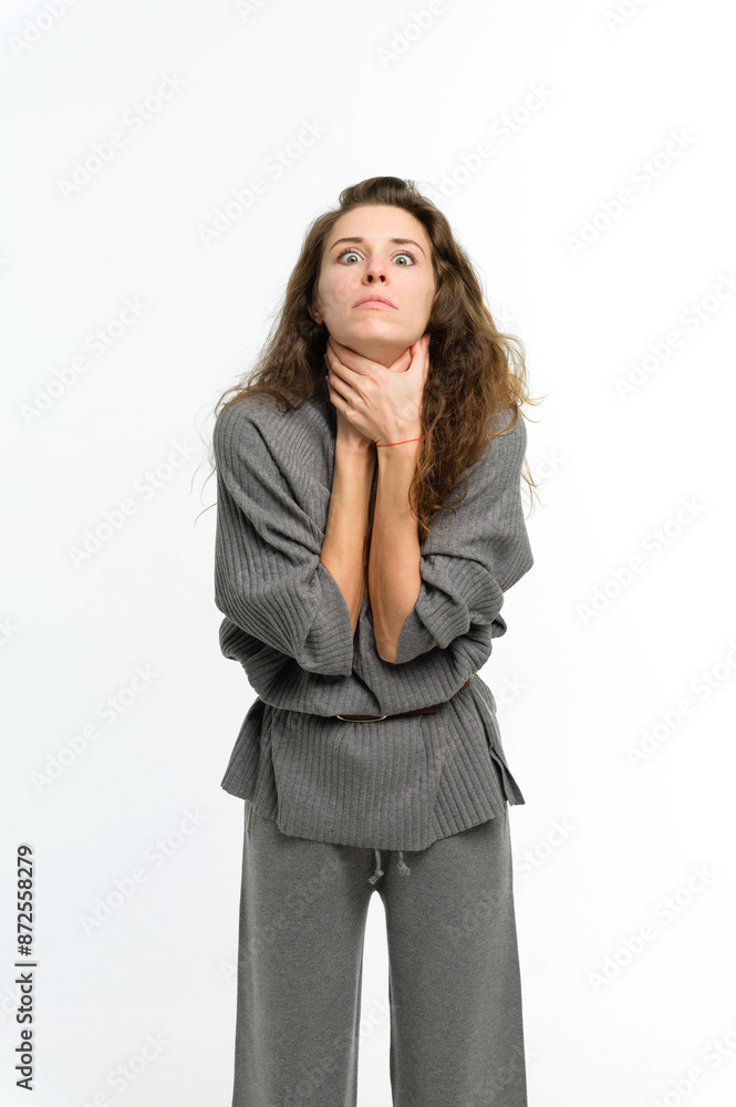 A young woman strangles herself. White background. A young woman strangles herself. White background.