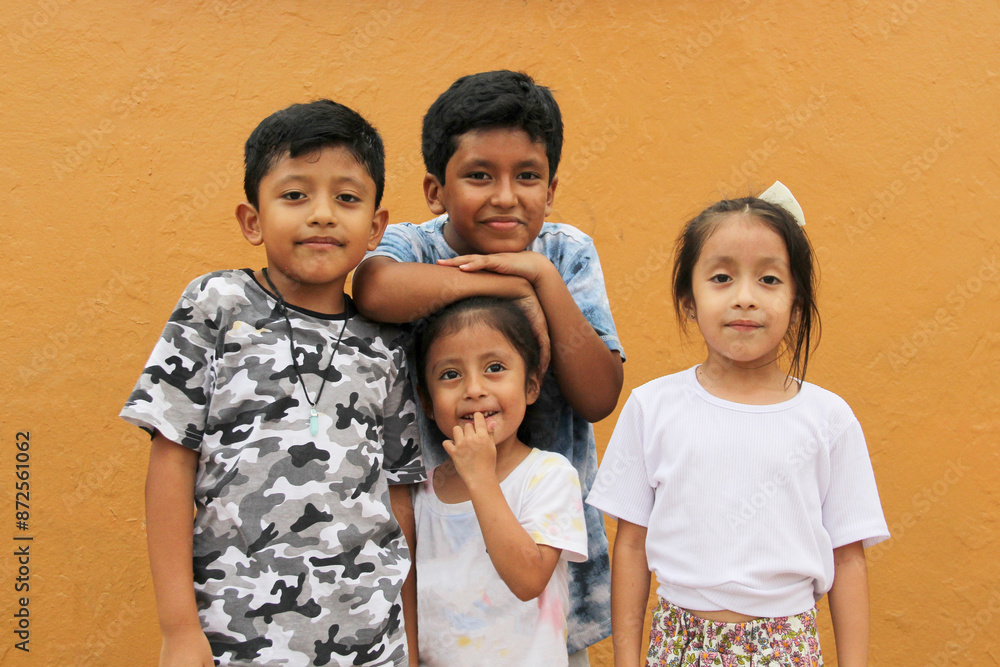 Two happy and excited dark-skinned Latino boys and 2 girls celebrate Children's Day by playing and laughing Two happy and excited dark-skinned Latino boys and 2 girls celebrate Children's Day by playing and laughing