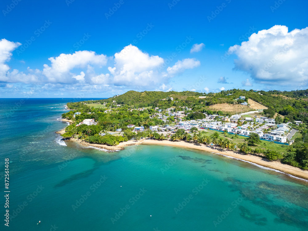 Naklejka premium Aerial coastline view of the beautiful oceanfront town of Rincon, Puerto Rico in the Caribbean