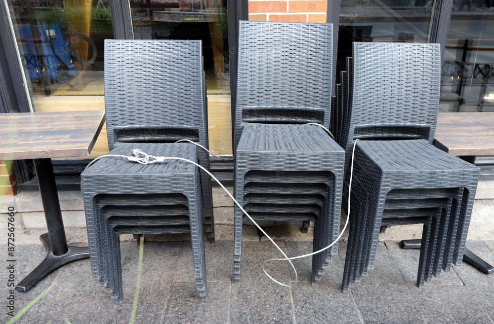 A lounge chair stands on the sidewalk on a street in a big city.
