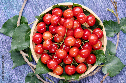 Red Cherry fruit in bamboo basket on on wooden background, Japanese Red highest variety of cherries on wooden table. photo