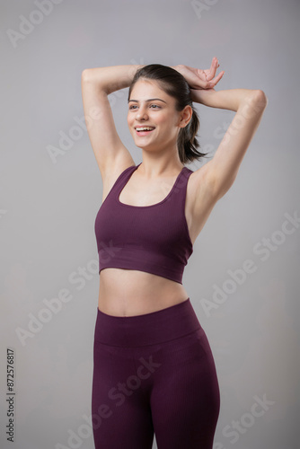 Young Woman In Gym Clothes Keeping Hands Behind The Head