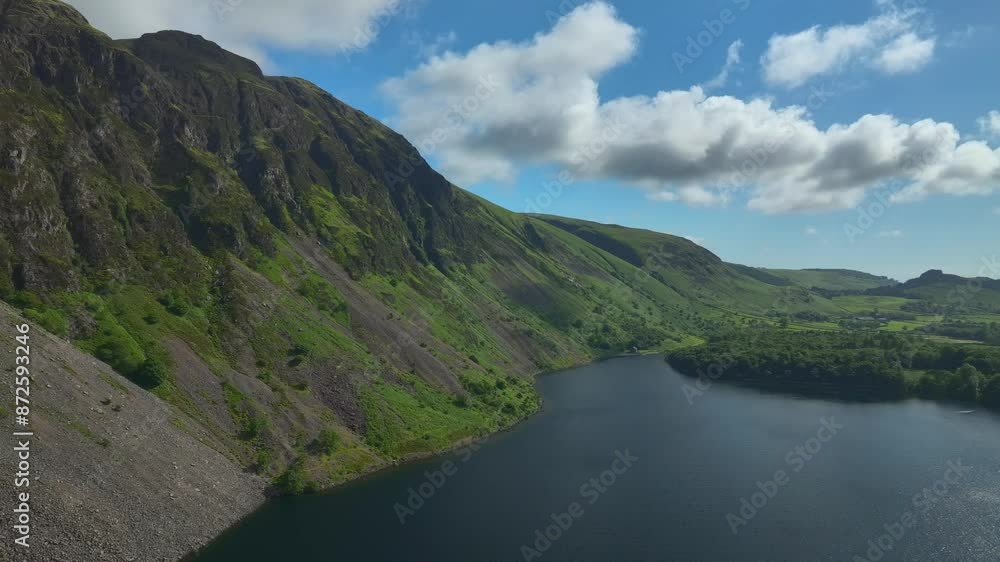 Flying over dark lake flanked by steep mountainside with drop-off to lowland wooded area. The Screes, Wastwater, Wasdale, Lake District, Cumbria, England, UK Flying over dark lake flanked by steep mountainside with drop-off to lowland wooded area. The Screes, Wastwater, Wasdale, Lake District, Cumbria, England, UK