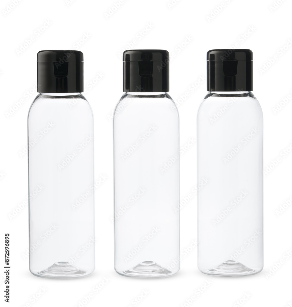 Three Clear Plastic Bottles With Black Caps on a White Background Three Clear Plastic Bottles With Black Caps on a White Background