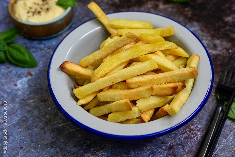Home made Fresh fried French fries in a bowl on wooden rustic background Home made Fresh fried French fries in a bowl on wooden rustic background