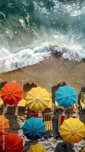 Aerial view of tropical beach scene in summer with beach umbrellas, beach chairs and the sea