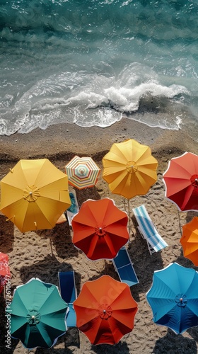 Aerial view of tropical beach scene in summer with beach umbrellas, beach chairs and the sea
