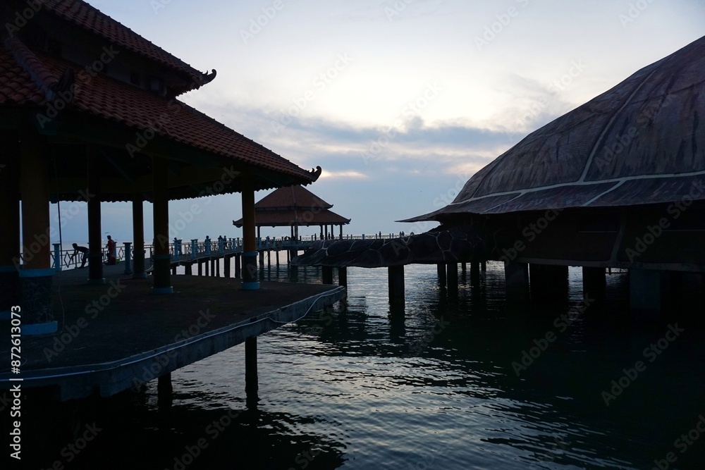 The large turtle statue on the edge of Kartini beach is one of the iconic landmarks in the city of Jepara. silhouette at sunset. The large turtle statue on the edge of Kartini beach is one of the iconic landmarks in the city of Jepara. silhouette at sunset.