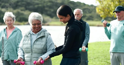 Fitness, dumbbells and old people in park with help, personal trainer and wellness in muscle training. Physio, woman and group of senior friends on grass for workout, stretching or mobility exercise