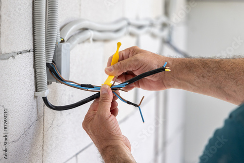 Repairman, Electrician Tying Bundle of Cables with a Tape