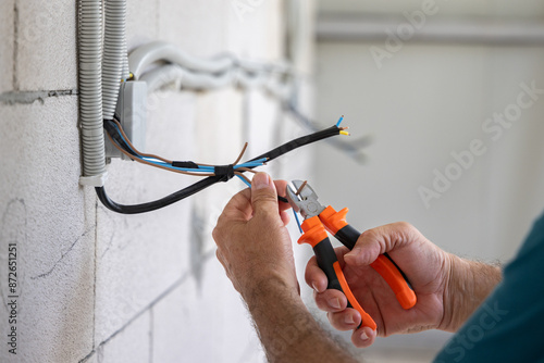 Electrician, Repairman Installing an Electrical Installation in a New Building