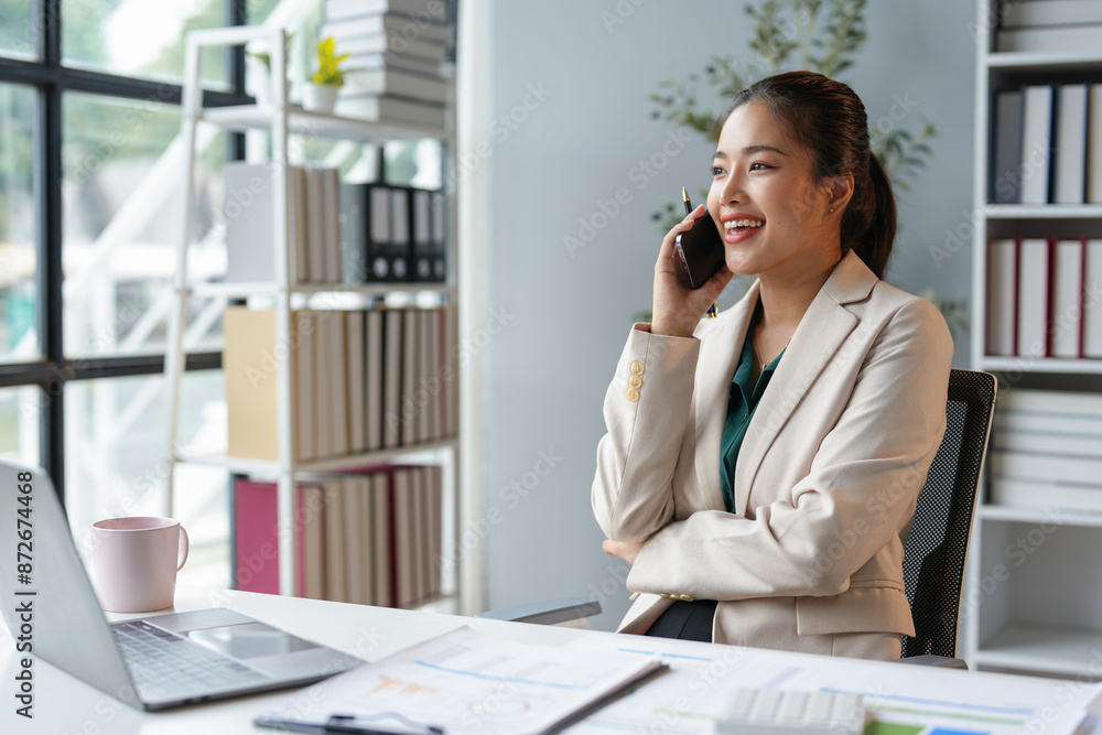 Asian businesswoman talking on the phone working in a modern office. Contacting customers. Customer manager, company sales. Contact online for finances startup business idea. Asian businesswoman talking on the phone working in a modern office. Contacting customers. Customer manager, company sales. Contact online for finances startup business idea.