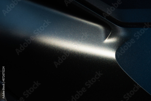 A close up of a car's hood with a shiny, reflective surface