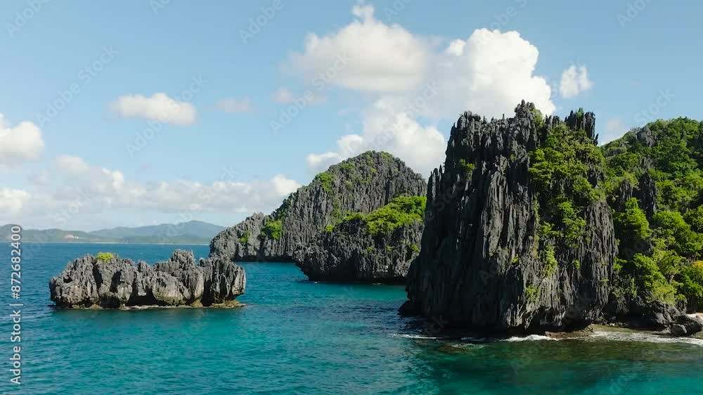 Flying over the sea to beautiful splendid limestone rock formation in tropical island. El Nido. Palawan, Philippines. Flying over the sea to beautiful splendid limestone rock formation in tropical island. El Nido. Palawan, Philippines.