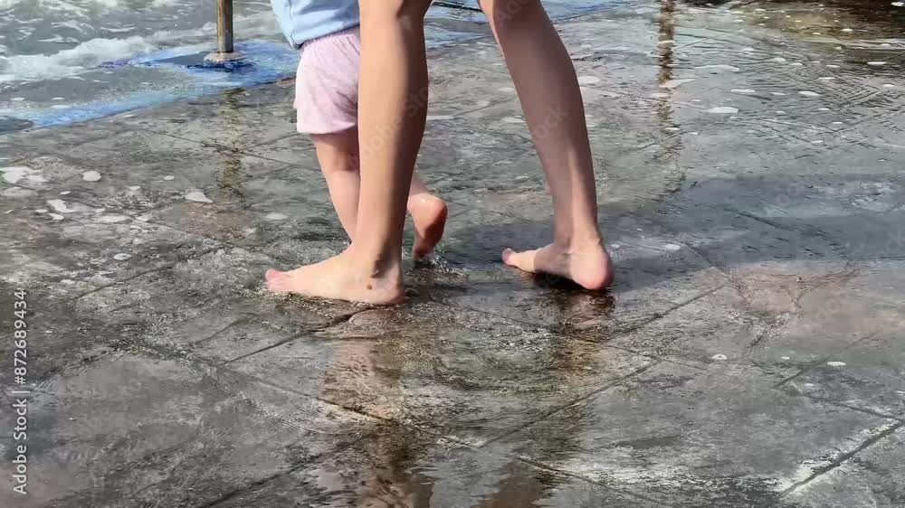 Child and Mother having fun Splashing water in the Sea. Splashing in Happiness. Child at the Seaside. Mother and Child Enjoying the Sea. Sea Adventures. Happy Child with Loving Mother. Child and Mother having fun Splashing water in the Sea. Splashing in Happiness. Child at the Seaside. Mother and Child Enjoying the Sea. Sea Adventures. Happy Child with Loving Mother.