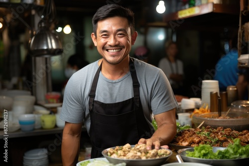 A smiling vendor at a vibrant street food stall with various dishes displayed.