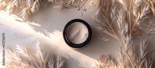 Spa cosmetic product displayed in a cream jar on a branding mock-up, with a top view against a feathered background, in a flat lay style with copy space image. photo