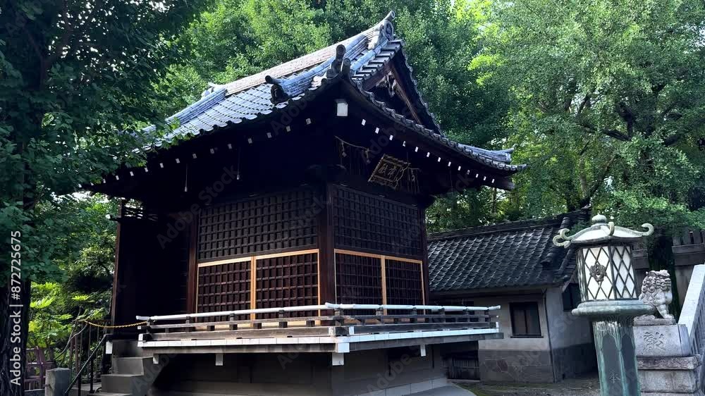 A traditional Japanese shrine surrounded by lush greenery on a sunny day, exterior view A traditional Japanese shrine surrounded by lush greenery on a sunny day, exterior view