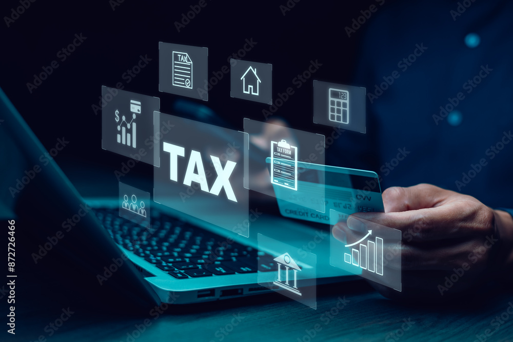 Hand using a laptop with TAX REFUND and refund tax of duty taxation business, graphs and chart being demonstrated on the screen media, tablet pc and selecting tax refund, Saving tax for business Hand using a laptop with TAX REFUND and refund tax of duty taxation business, graphs and chart being demonstrated on the screen media, tablet pc and selecting tax refund, Saving tax for business