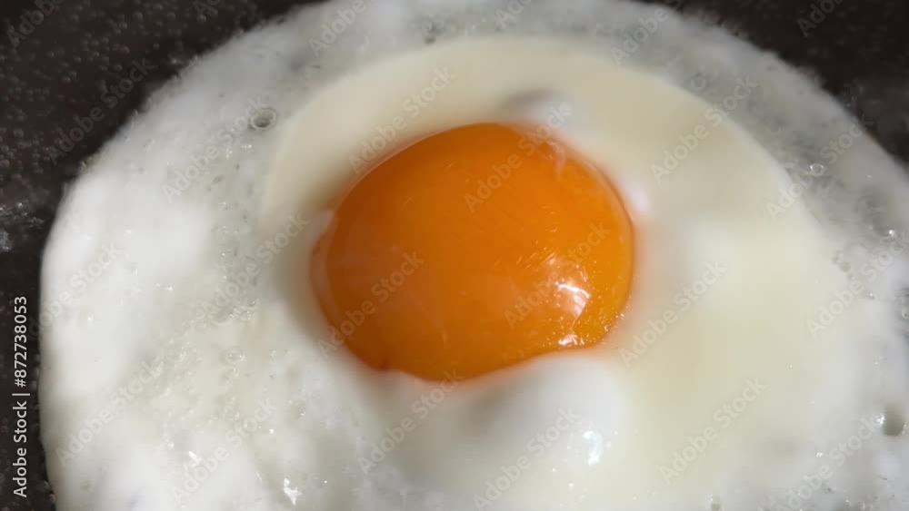 Scrambled eggs are fried in a frying pan in oil. Scrambled eggs are fried in a frying pan in oil.