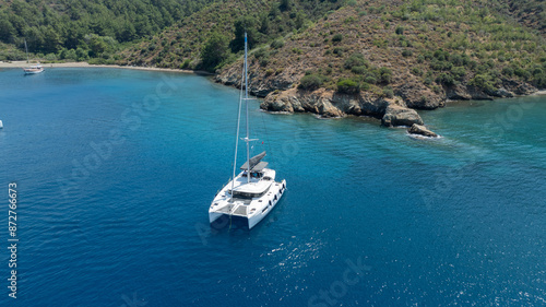 Aerial drone photo of beautiful catamaran sailing yacht anchored in tropical exotic turquoise sea exotic bay