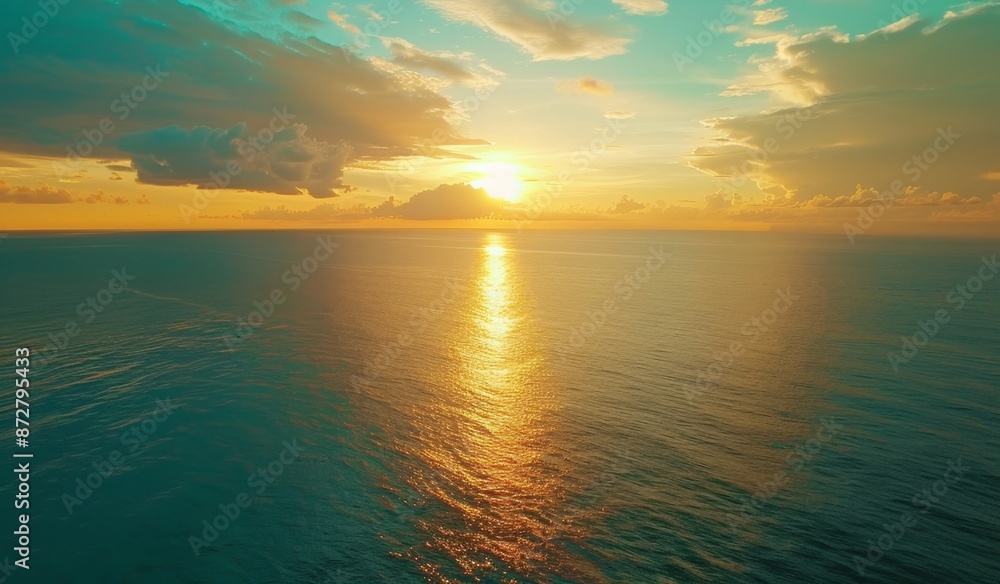 Obraz premium Beautiful sunset over the ocean with a blue sky, scenic view, calm seawater, drone aerial shot