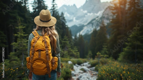 Image showcases a solo hiker with a yellow backpack standing in a mountainous landscape, surrounded by pine trees and rocky paths, emphasizing adventure and exploration. © Vuvimages
