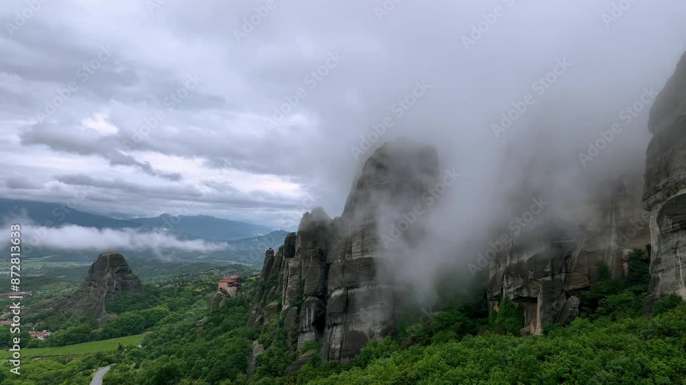 Drone flight among mists creeping around the picturesque rocks and the old monastery buildings in the Meteora Valley near Kastraki, Greece Drone flight among mists creeping around the picturesque rocks and the old monastery buildings in the Meteora Valley near Kastraki, Greece