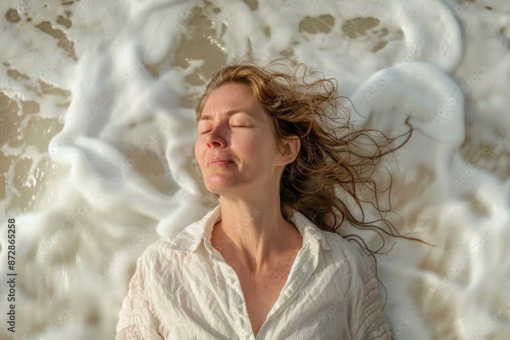 Portrait of a content woman in her 40s wearing a simple cotton shirt isolated on crashing waves background Portrait of a content woman in her 40s wearing a simple cotton shirt isolated on crashing waves background